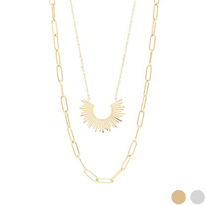 Gold necklace with a sunburst pendant on a white background