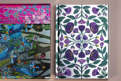 Two notebooks with colorful floral patterns on a neutral background